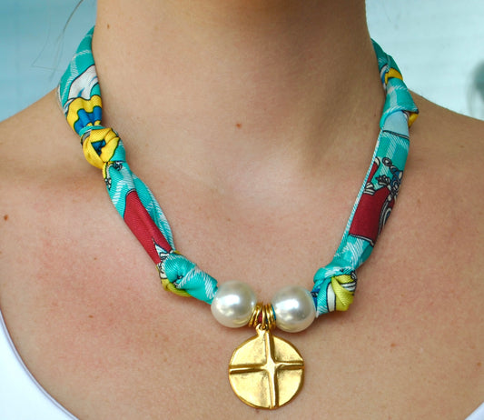 Teal multicolor silk scarf necklace with pearl beads and gold coin cross pendant worn around neck